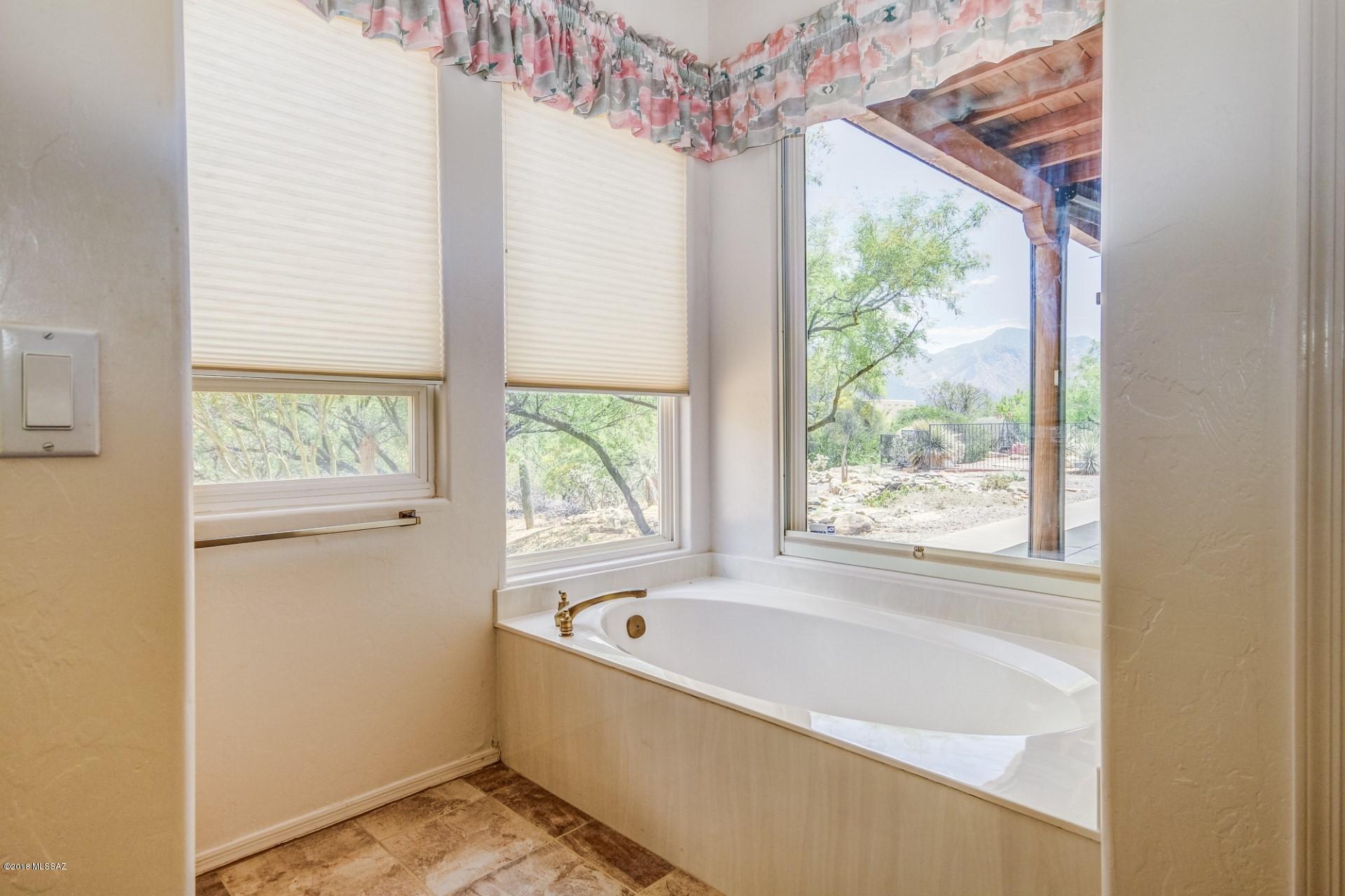 14480 North Swan Road Tucson, AZ 85739 - Photo 18 of 31 a bathroom with a bathtub and window