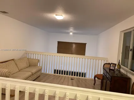 a bedroom with furniture and wooden floor