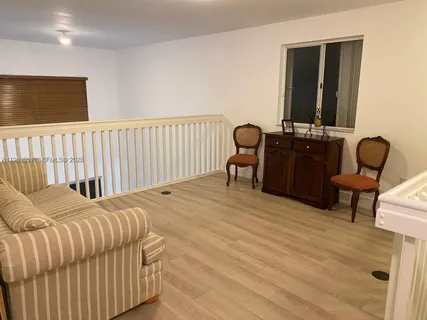 a bedroom with a bed and chair