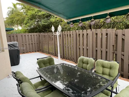 a living room with furniture and a wooden fence