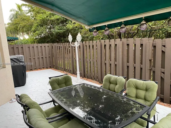 a living room with furniture and a wooden fence