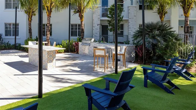 a swimming pool with outdoor seating and yard