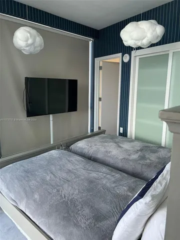a bedroom with a bed and a television