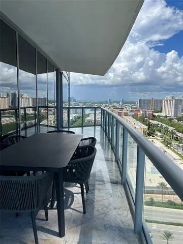 a view of a balcony dining room and kitchen