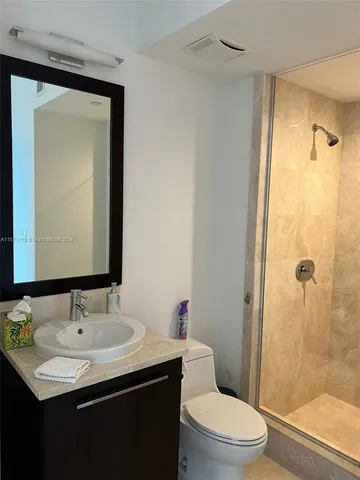 a bathroom with a sink toilet and shower