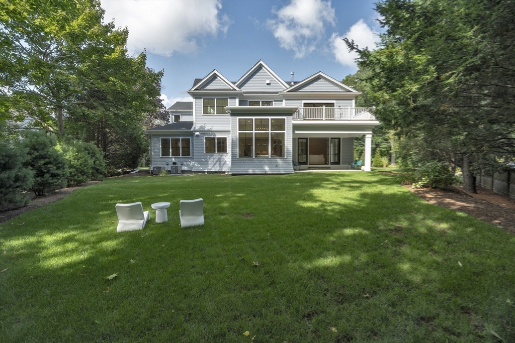 18 Sprague Road Wellesley, MA 02481 - Photo 32 of 35 a front view of a house with a yard table and chairs