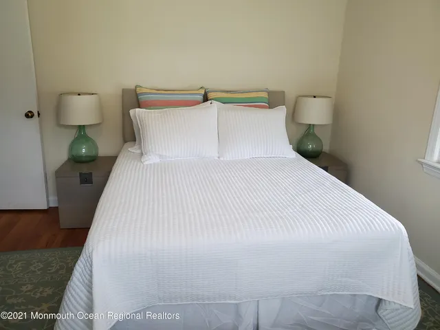 a large bed sitting in a bedroom next to a lamp