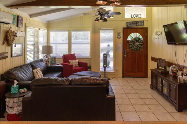a living room with furniture and a flat screen tv