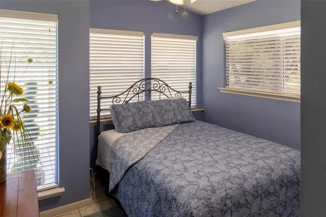 a large bed sitting in a bedroom next to a window