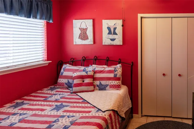 a bed sitting in a bedroom next to a window