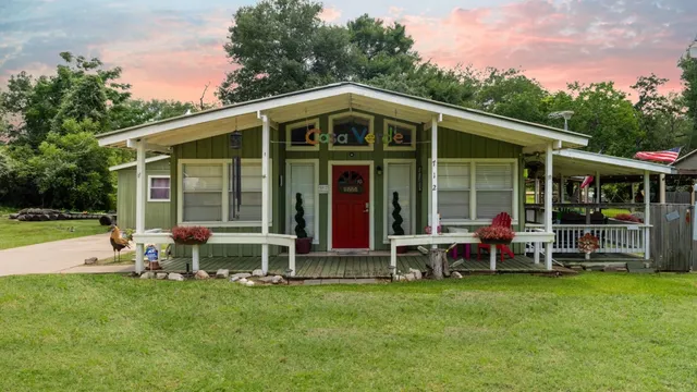 a front view of house with yard and outdoor seating