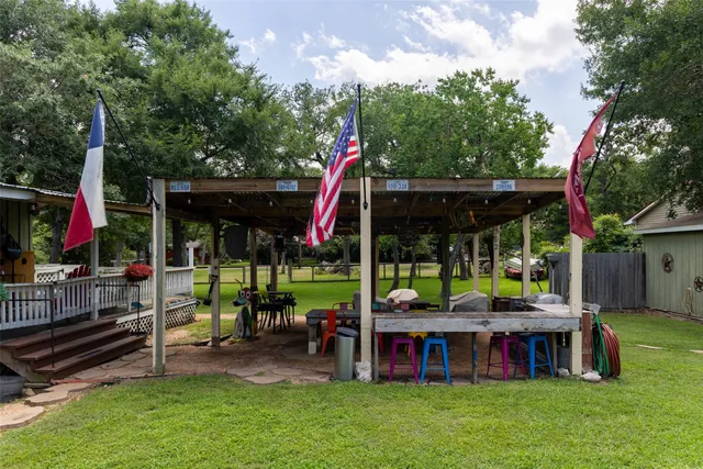 a view of a house with backyard and sitting area