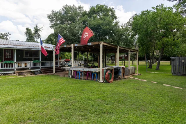 a yellow house with a wooden fence