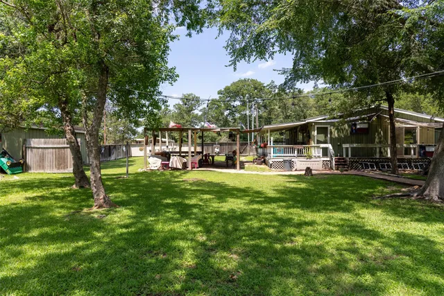 a view of a house with backyard and sitting area