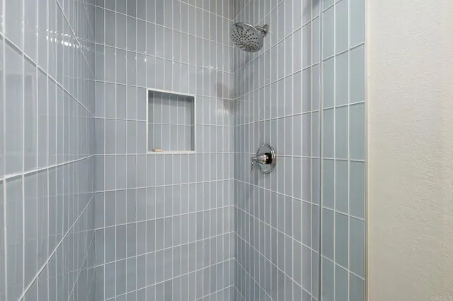 a bedroom with a bed and a lamp