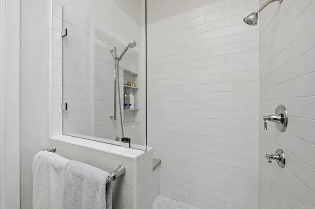 a view of a patio with table and chairs under an umbrella
