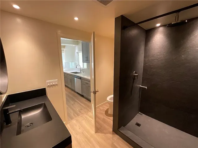 an empty room with wooden floor and entrance