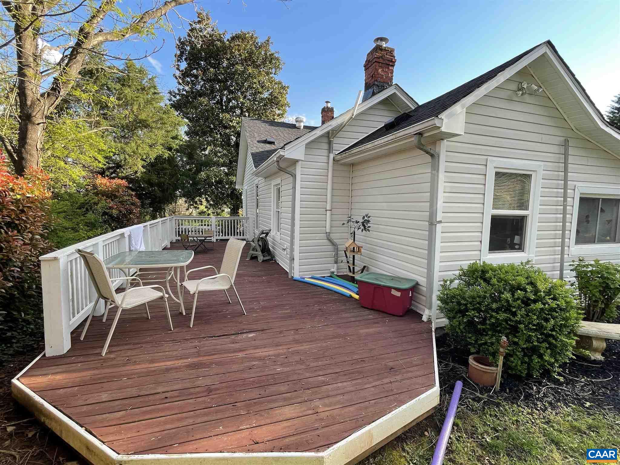 5674 Three Notch'd Road Crozet, VA 22932 - Photo 6 of 8 a view of a patio with table and chairs with wooden floor and plants