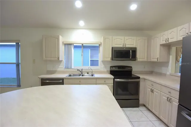 a kitchen with a sink stove and cabinets