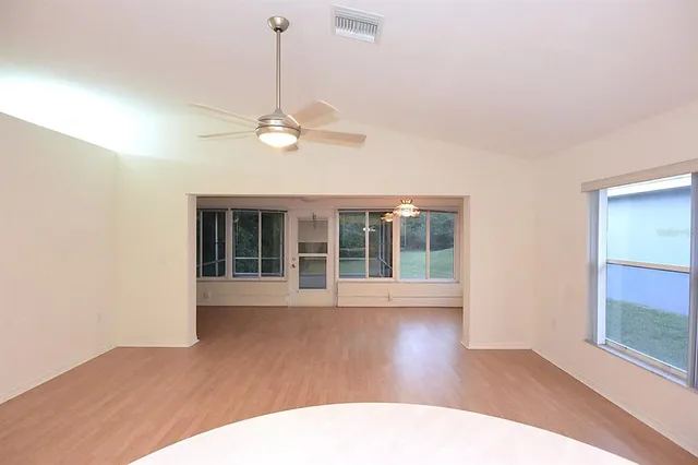 a view of a kitchen with a sink microwave and cabinets