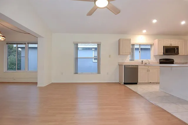 an empty room with closet and a ceiling fan