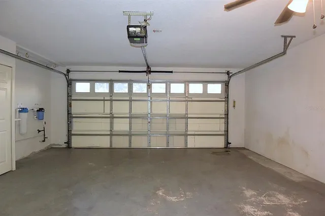a view of a kitchen with refrigerator and a sink