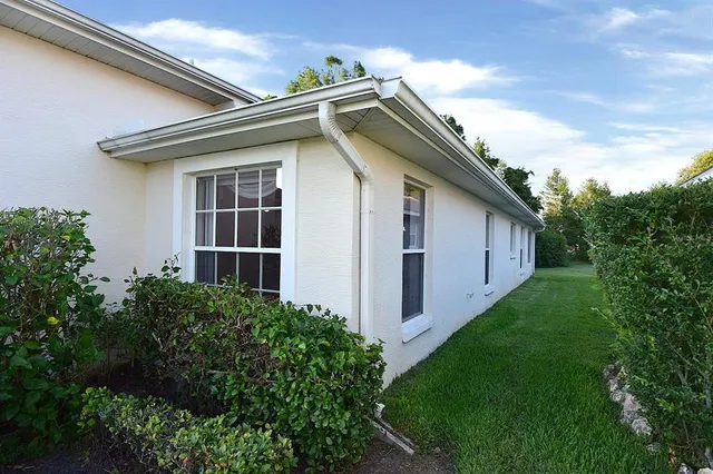 a view of a house with yard and sitting area