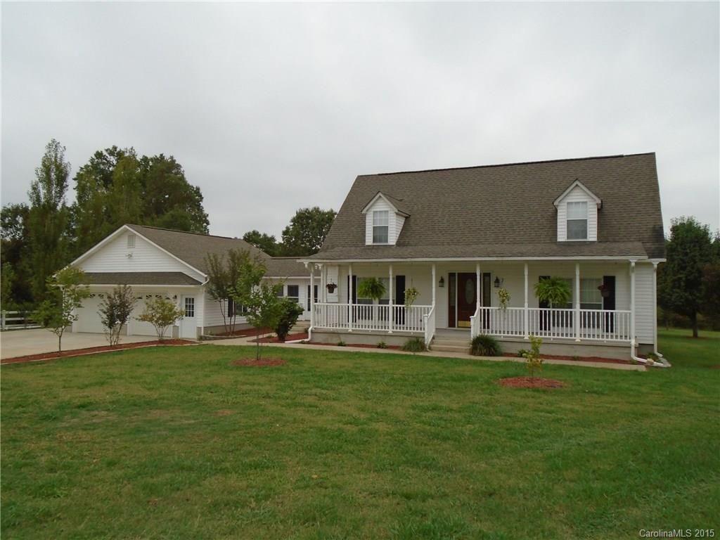 a front view of a house with a yard table and chairs