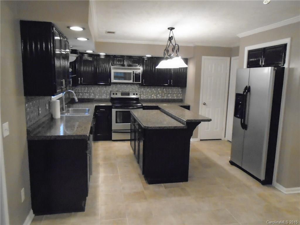 1260 Wayfield Road, Unit 3 Clover, SC 29710 - Photo 3 of 24 a kitchen with stainless steel appliances granite countertop a sink a stove and a refrigerator