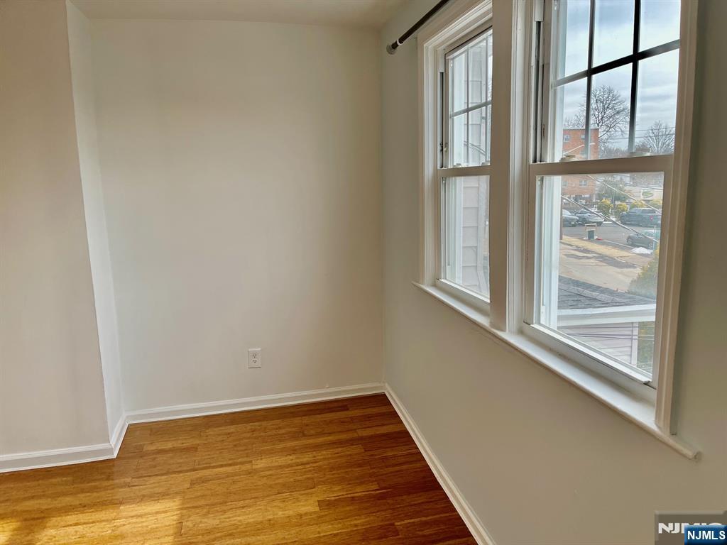 46 Webster Street, Unit 2 Ridgefield Park, NJ 07660 - Photo 6 of 10 a view of an empty room with wooden floor and a window
