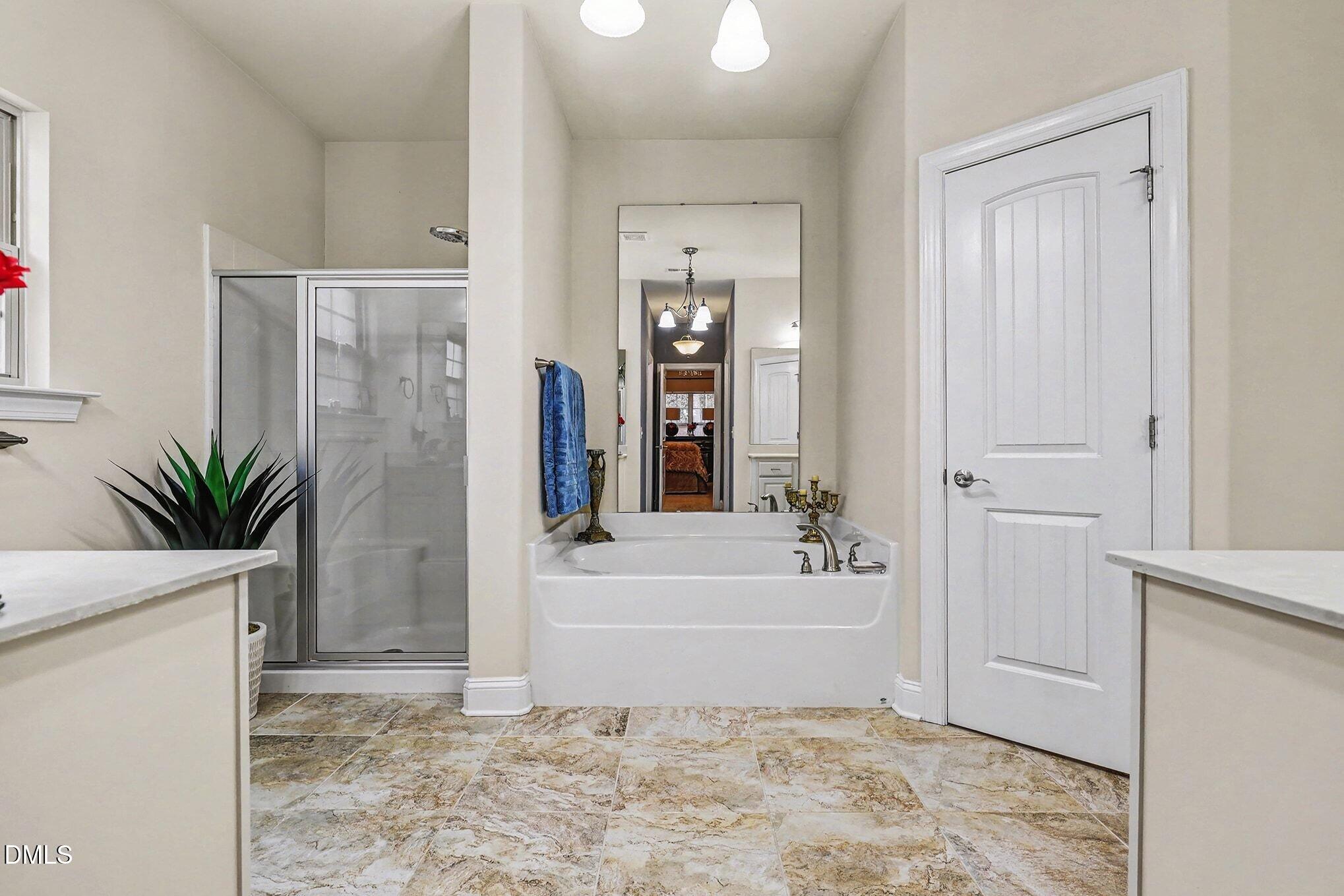 128 Dereham Lane Garner, NC 27529 - Photo 17 of 29 a bathroom with a tub shower and a sink