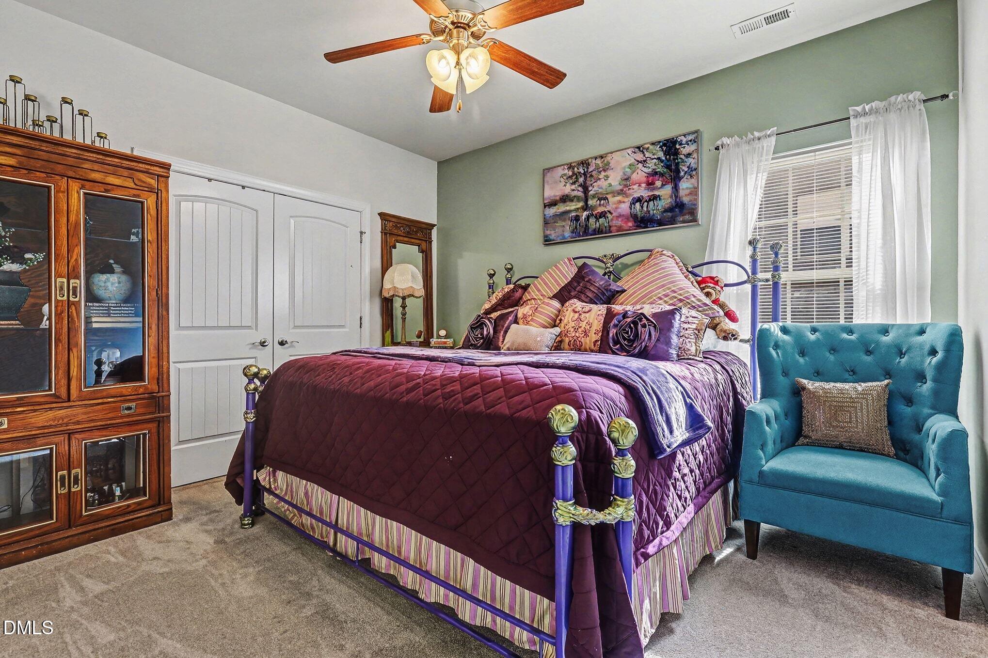 128 Dereham Lane Garner, NC 27529 - Photo 20 of 29 a bed room with a bed and a painting on the wall