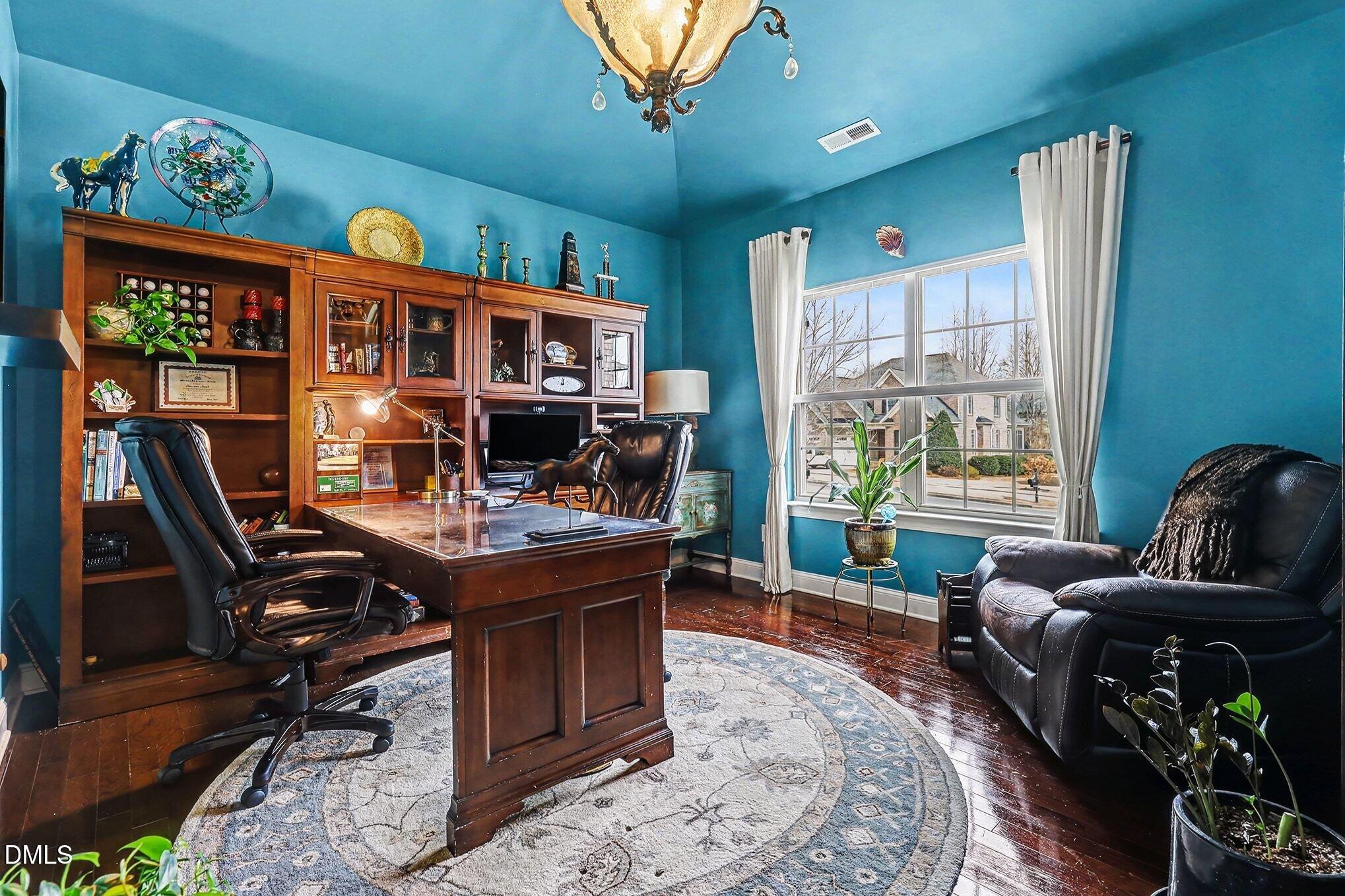 128 Dereham Lane Garner, NC 27529 - Photo 27 of 29 a living room with furniture a rug and a large window