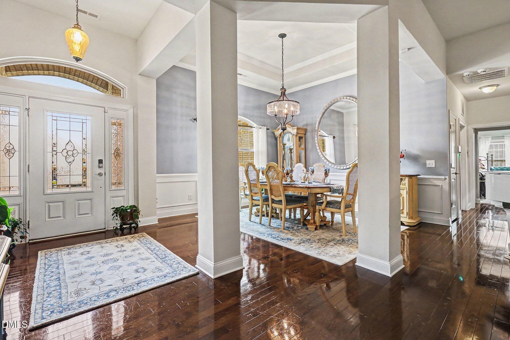 128 Dereham Lane Garner, NC 27529 - Photo 4 of 29 a view of an entryway with a chandelier