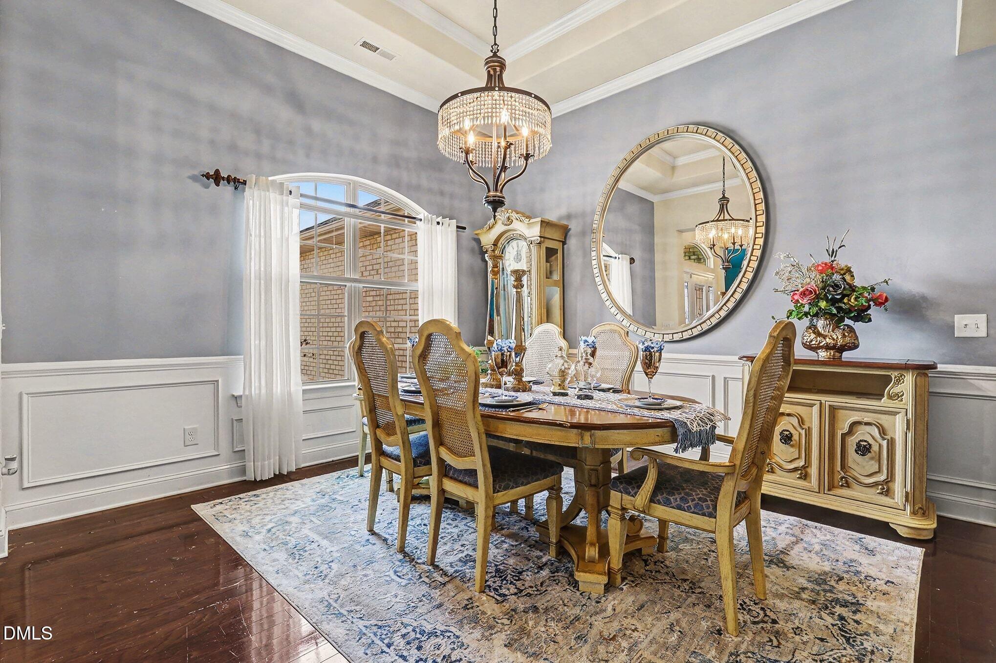 128 Dereham Lane Garner, NC 27529 - Photo 5 of 29 a view of a dining room with furniture and chandelier