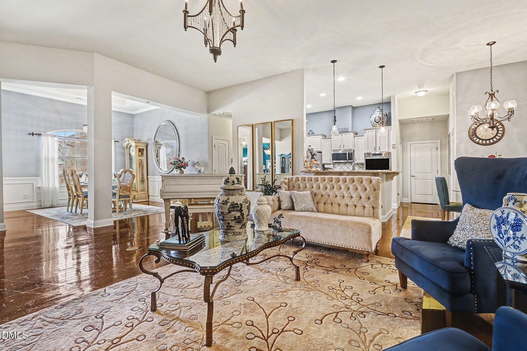 128 Dereham Lane Garner, NC 27529 - Photo 6 of 29 a living room with furniture kitchen view and a chandelier