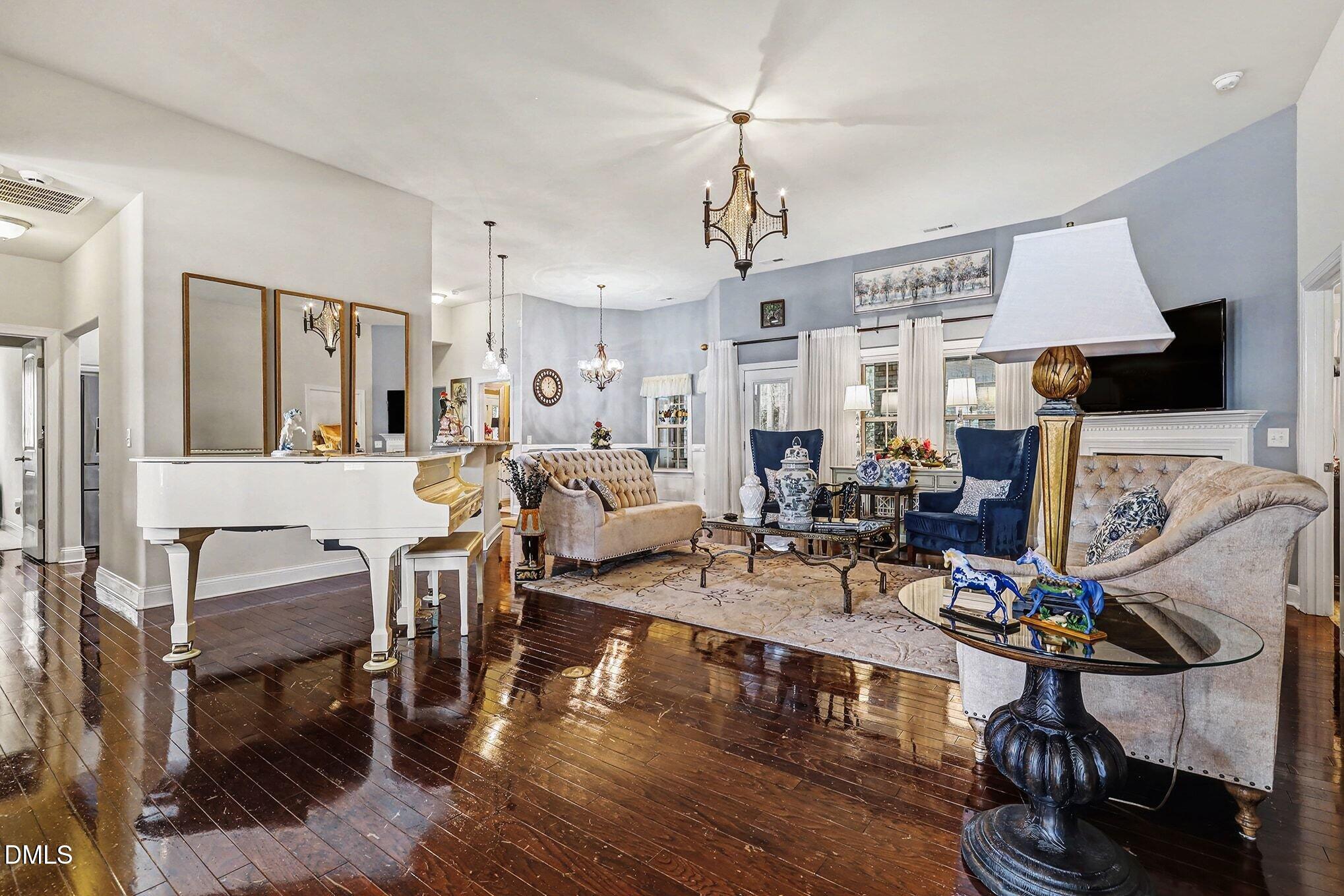 128 Dereham Lane Garner, NC 27529 - Photo 7 of 29 a living room with furniture a dining table and a fireplace