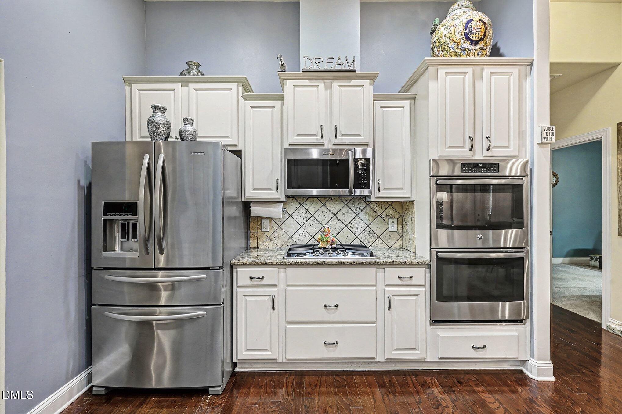 128 Dereham Lane Garner, NC 27529 - Photo 8 of 29 a kitchen with stainless steel appliances granite countertop a refrigerator and a stove top oven