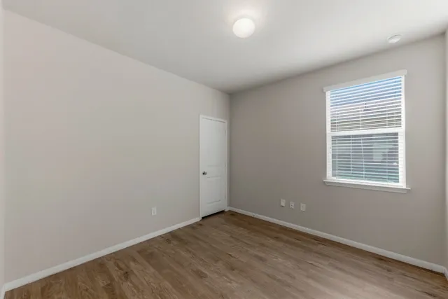 a view of walk in closet with wooden floor and cabinet
