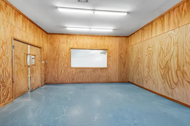 an empty room with wooden floor and walls