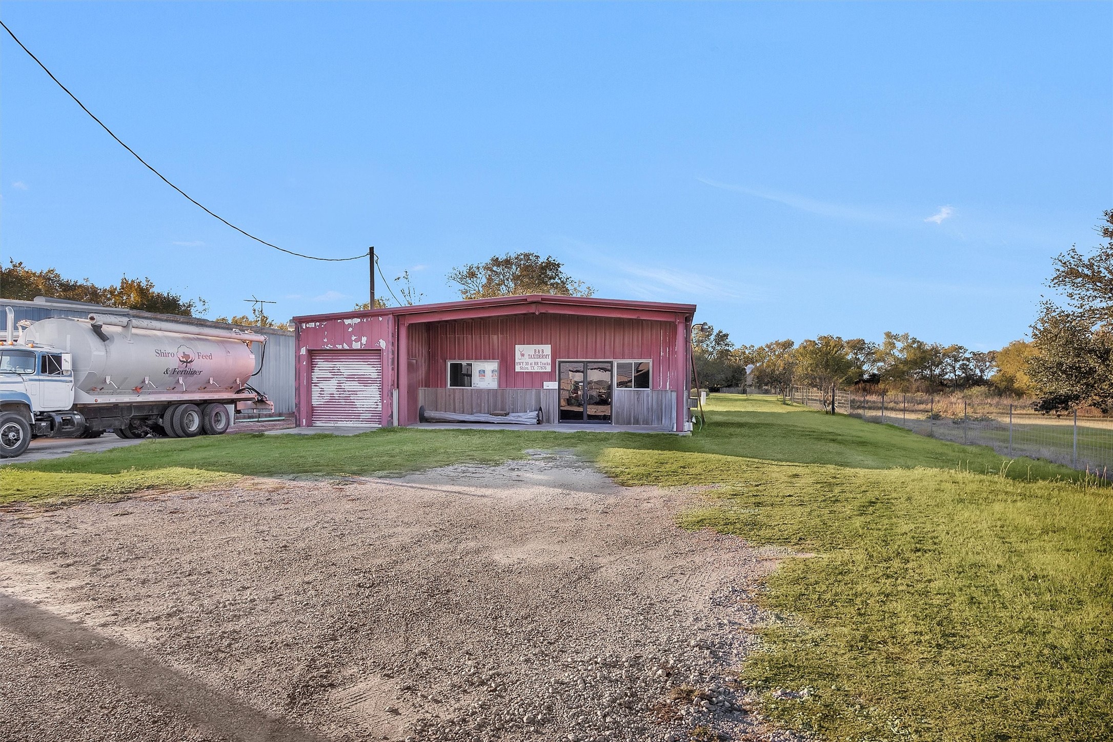 6821 Bailey Street Shiro, TX 77831 - Photo 2 of 35 a view of a house with a yard and a large tree