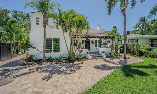 a front view of a house with garden
