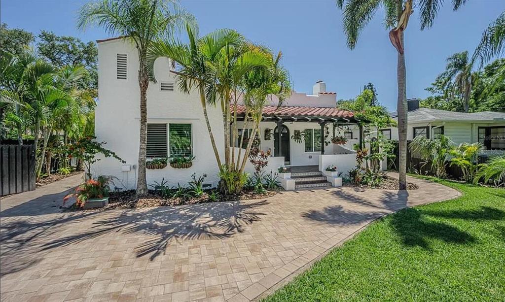 a front view of a house with garden