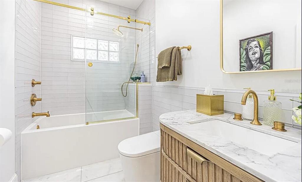 1175 Jackson Road Clearwater, FL 33755 - Photo 16 of 23 a bathroom with a granite countertop bathtub sink vanity mirror and toilet