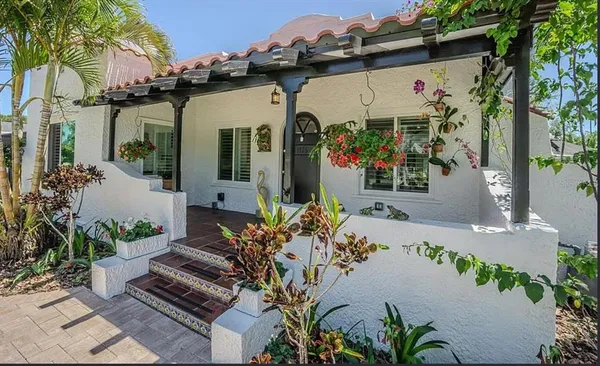 a view of backyard with a garden and palm trees