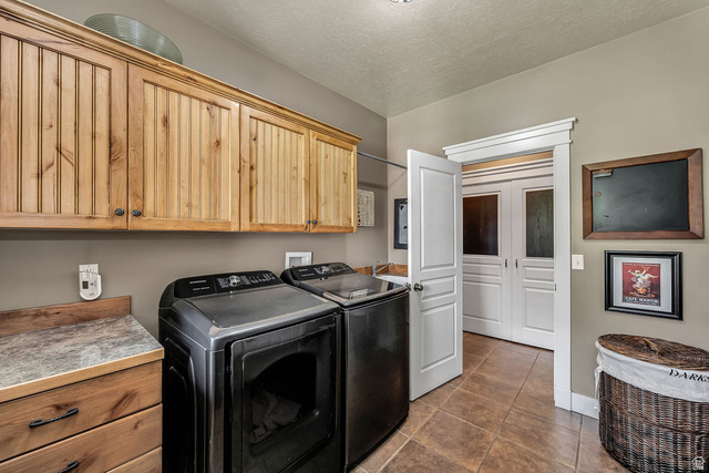 288 525 South Providence, UT 84332 - Photo 14 of 71 Laundry area featuring wood-finish cabinetry, a coordinating wood-finish countertop, and tiled flooring