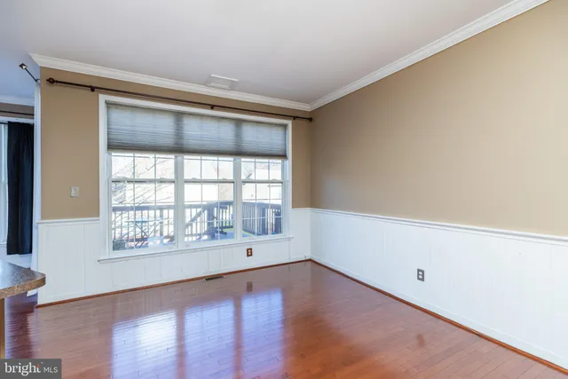 a large kitchen with a large window a sink and stainless steel appliances