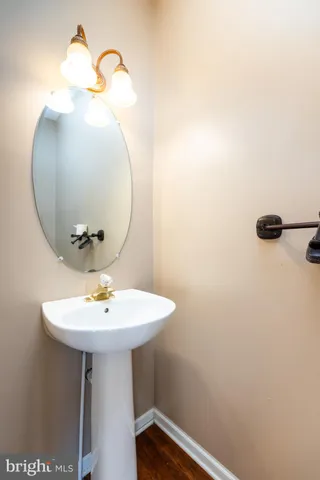 an empty room with chandelier fan and windows