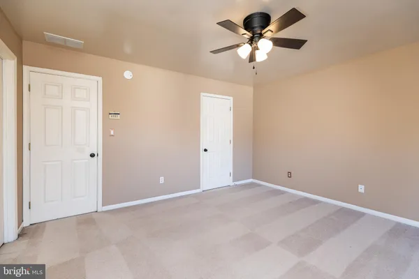 a bathroom with a double vanity sink and mirror with bathtub