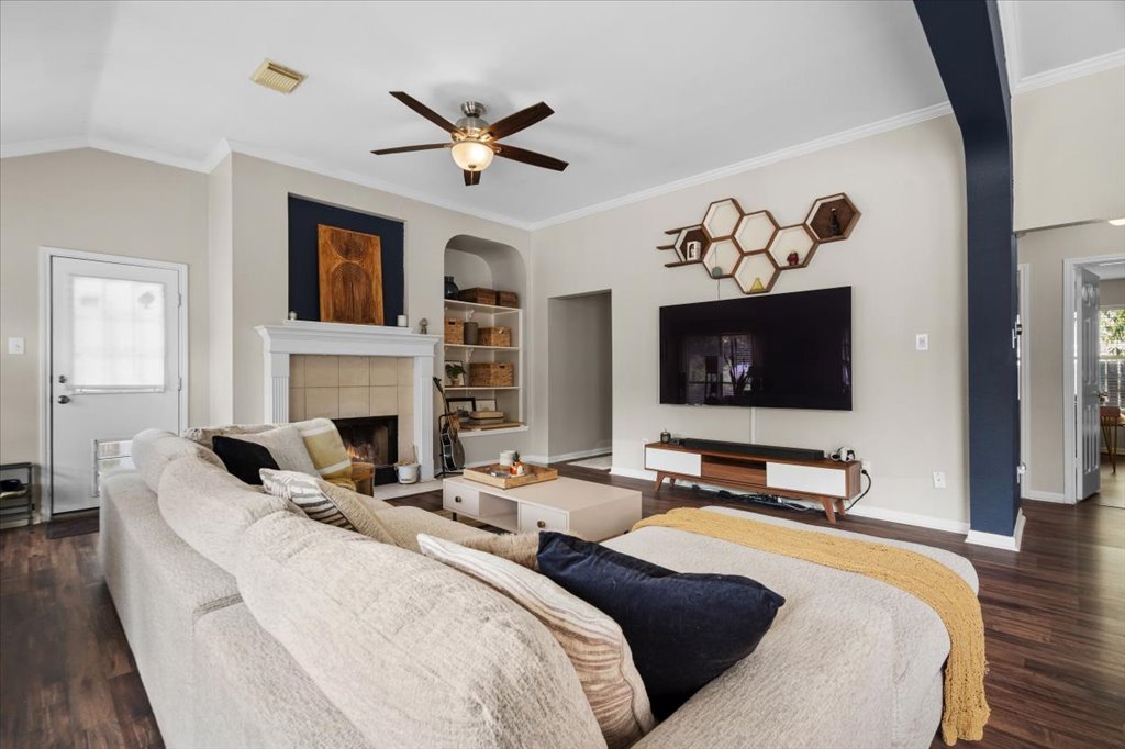 13200 Calf Roping Trail Austin, TX 78727 - Photo 15 of 28 Rich wood floors and a classic fireplace anchor this inviting, open living space.